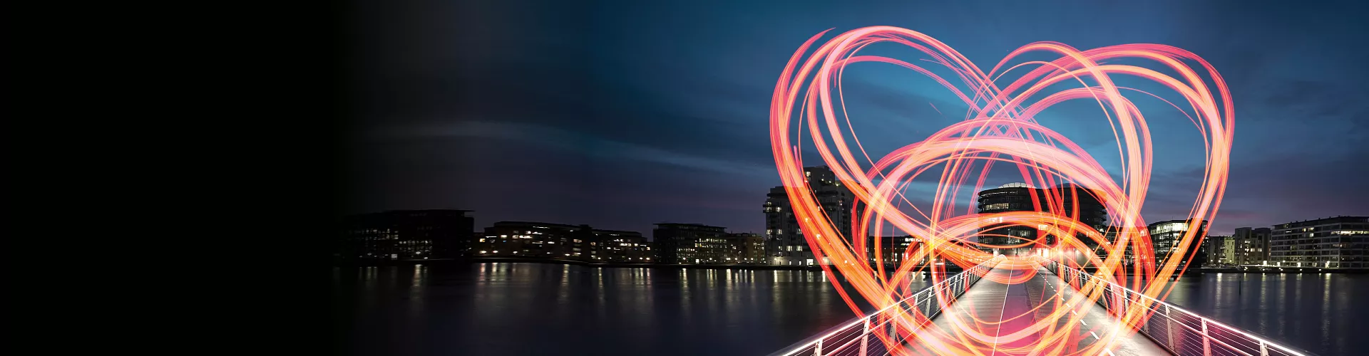 Bridge in the foreground, city skyline in the background