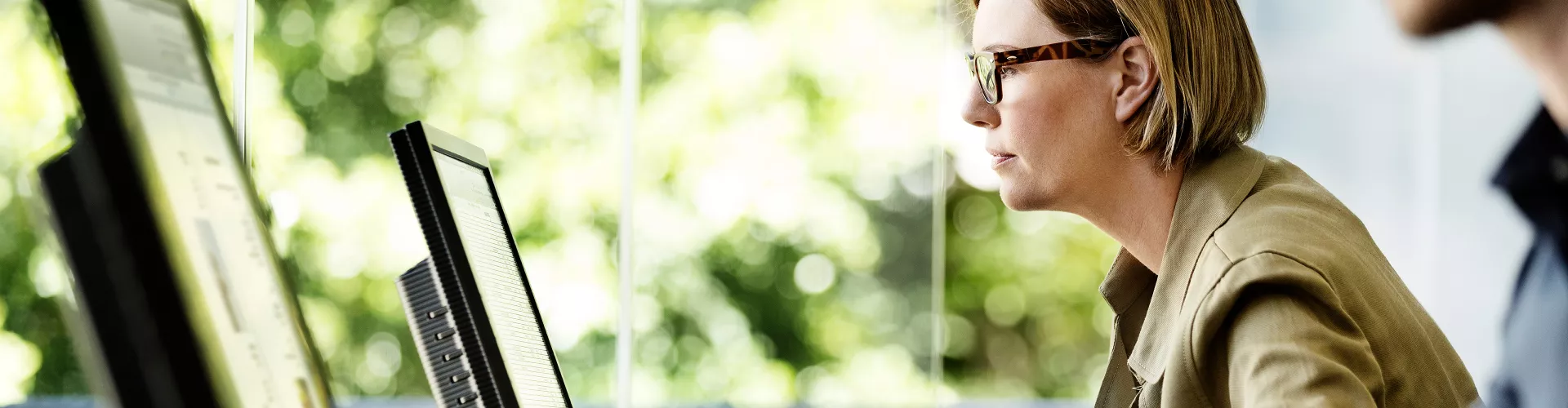 woman sitting in front of a computer screen