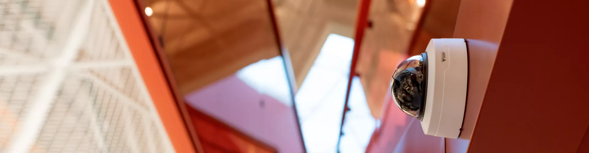 AXIS P32 camera mounted on a red wall