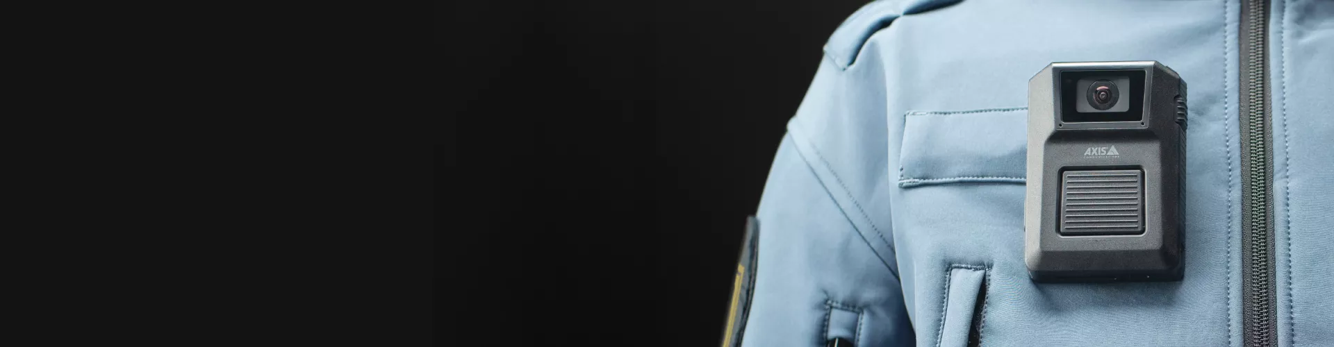 closeup image of a security guard, wearing an axis body worn camera