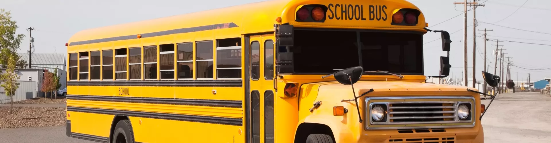 Large yellow school bus. Warm and dry weather in the surroundings.