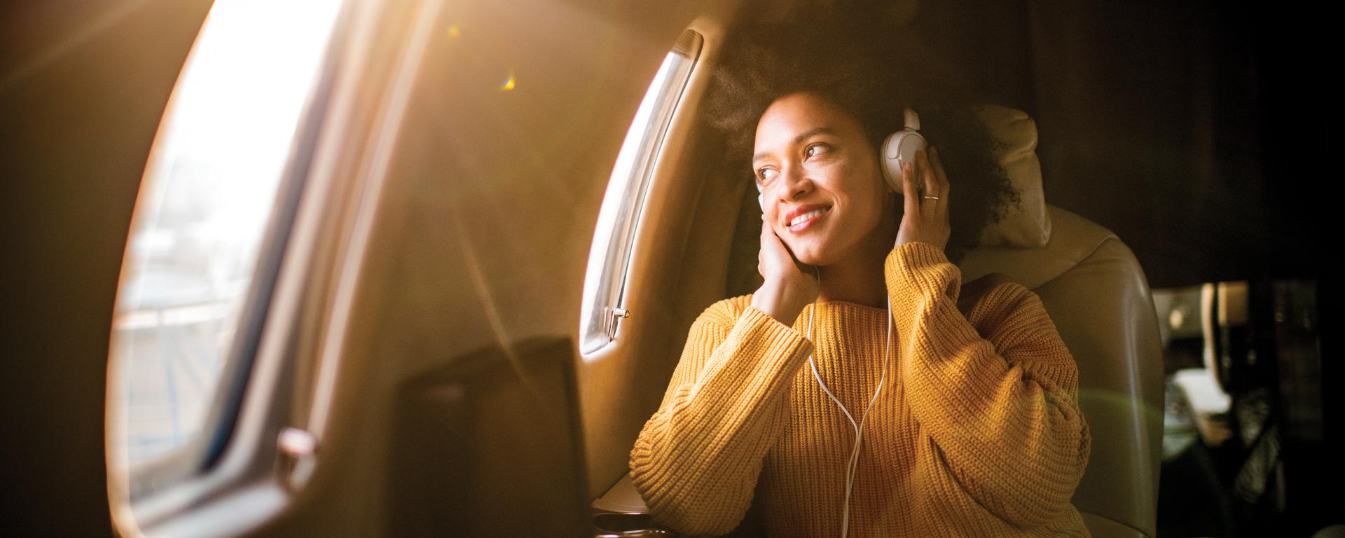 Woman flying airplane with headphones