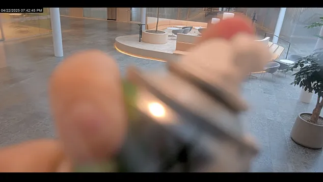 Footage on monitor of a person spraying the lens.