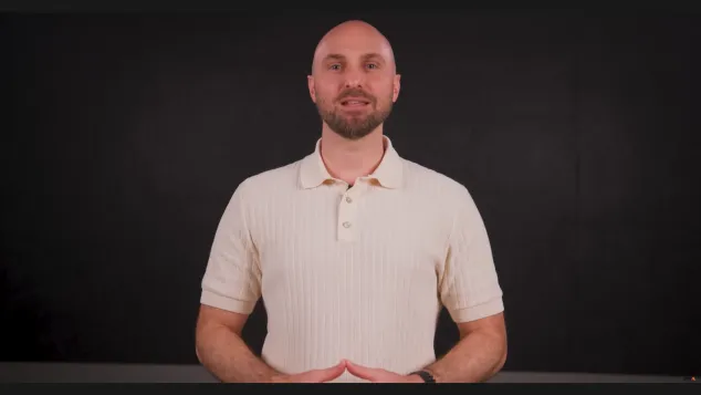 Steve Burde standing in the middle with a black background behind him.