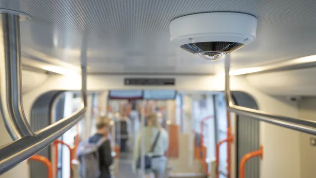 AXIS M3057-PLR Mk II Dome Camera mounted on the ceiling inside a tram.