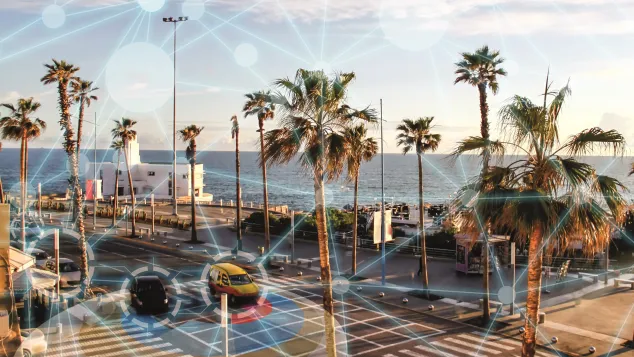 Cars driving by a sunny beach with analytics overlay.
