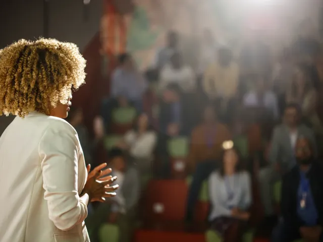 Woman delivering a speech at a conference.