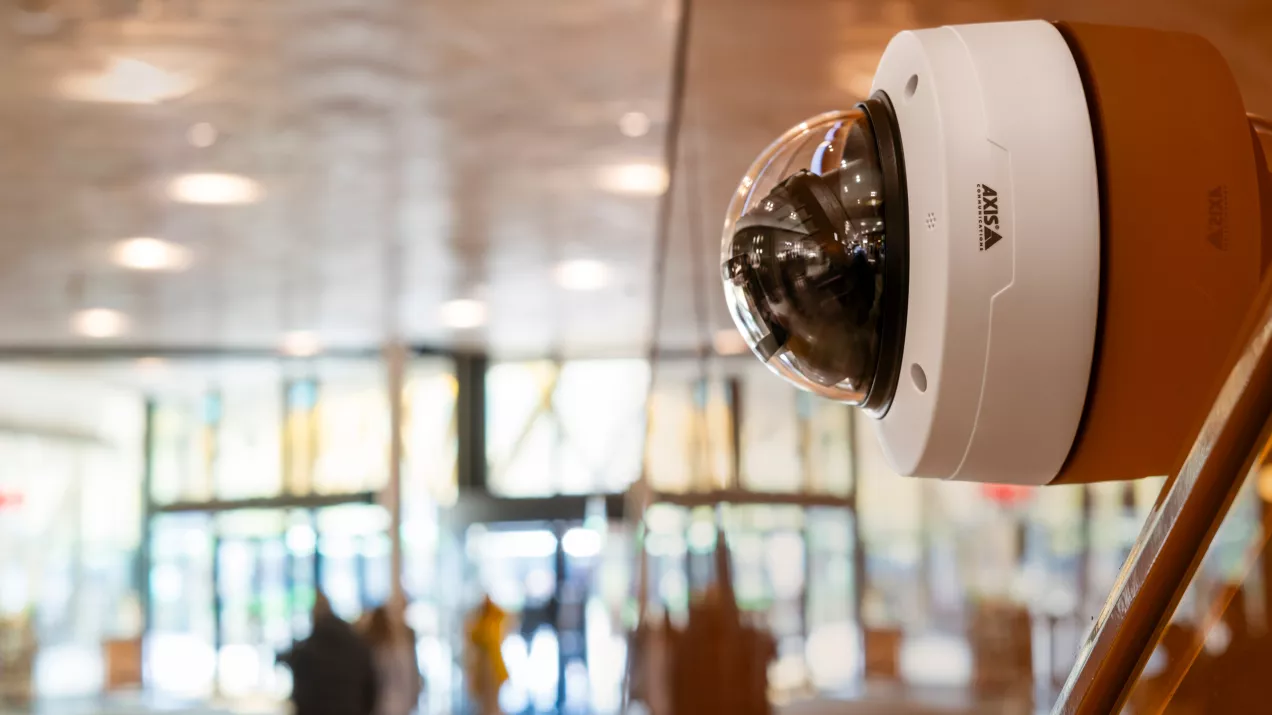 AXIS p3285-87-88 products mounted on a wall in a mall.