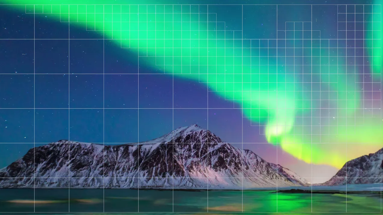 Mountain on the horizon of the sea with northern lights shining in the dark blue sky.