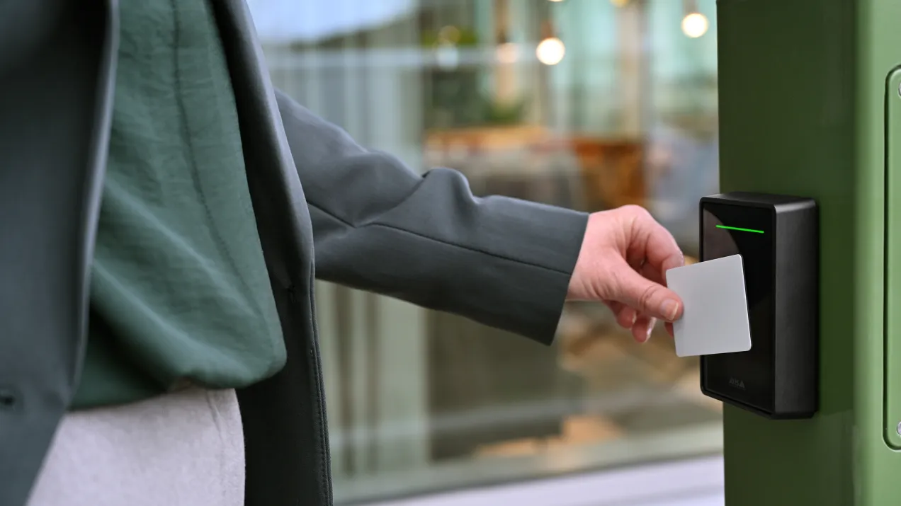 person using a card at an access control port