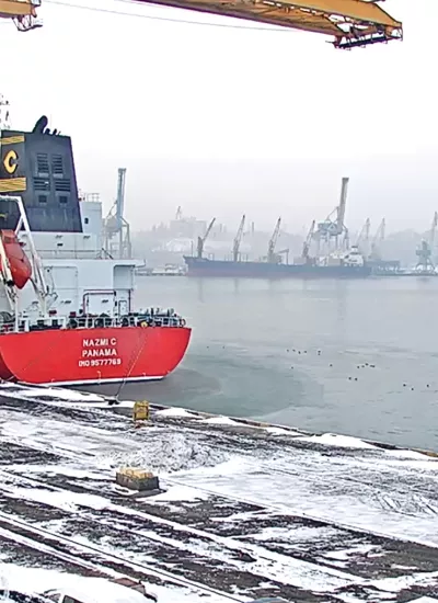 Sea port in winter with a ship close by.