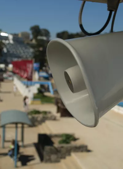 Closeup of Axis C3003-E in outdoor environment, viewed from its left angle.