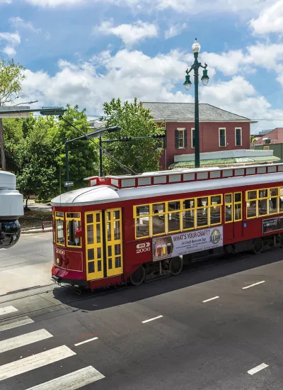 Axis pole camera with red and yellow trolley in background.