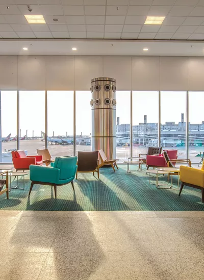 Gate waiting area viewing airplanes outside.