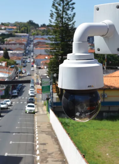 Axis Q6114-E viewed from its left angle with city street in background.