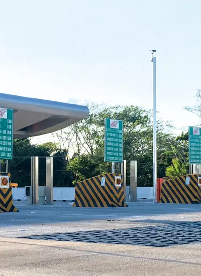 Toll booths for cars, green instruction signs.