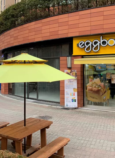 Eggbox exterior with ourdoor tables