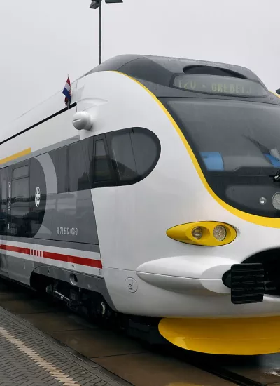 Modern train at platform with people