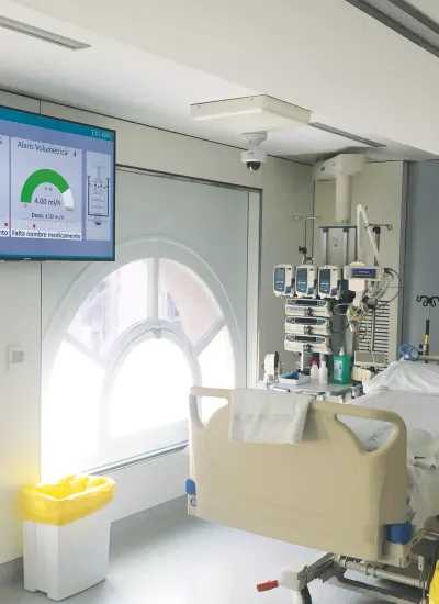 Room with hospital bed and ceiling cameras