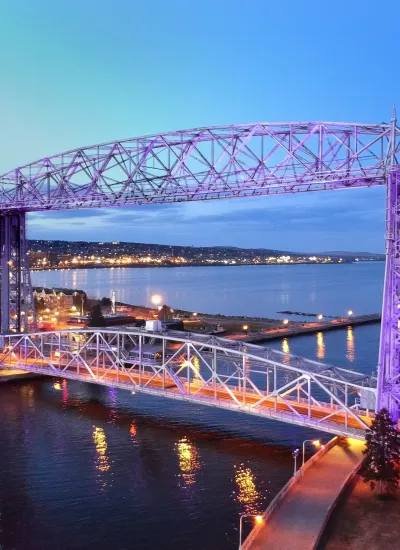 Aerial lift bridge in Duluth, MN at dusk with purple lights