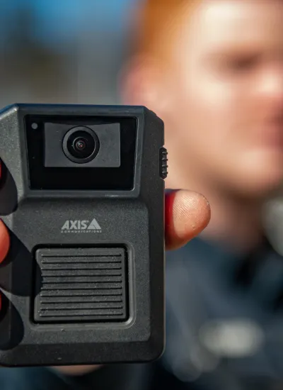 Axis body worn camera held out by officer