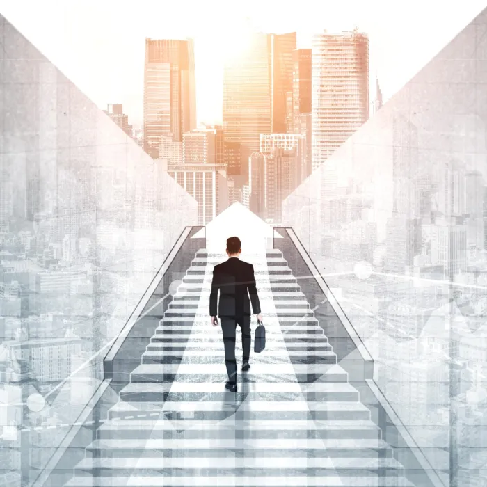 Man walking in a staircase holding a briefcase.