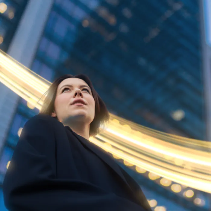 woman looking up at skyline