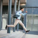Man jumping with backpack