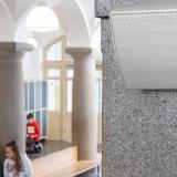 Speaker mounted high upon a wall