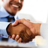 2 men handshake blurred