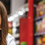Smiling person with brown hair in grocery store