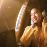 Woman flying airplane with headphones