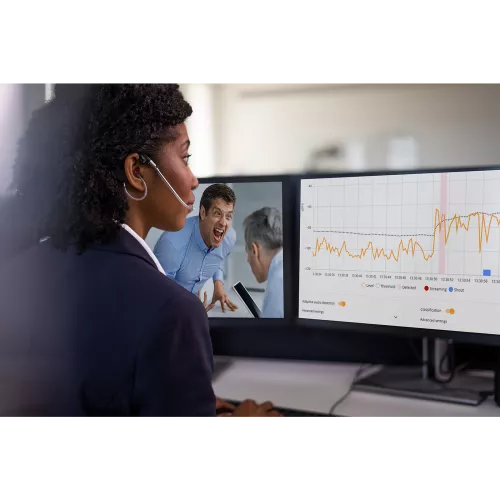woman monitoring two screens