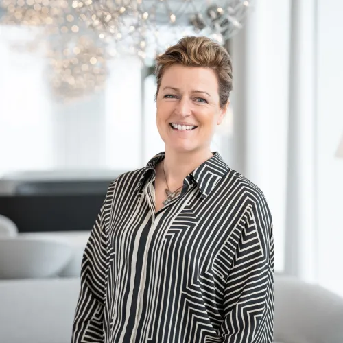 Louise Hobroh smiling in a open office space.