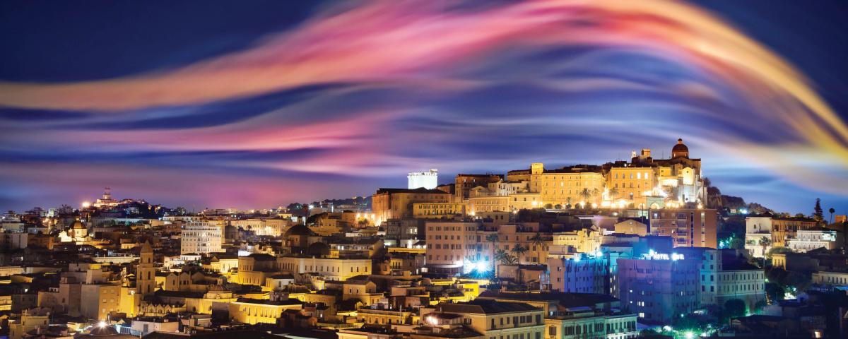 Pink, purple and orange skyes over a city