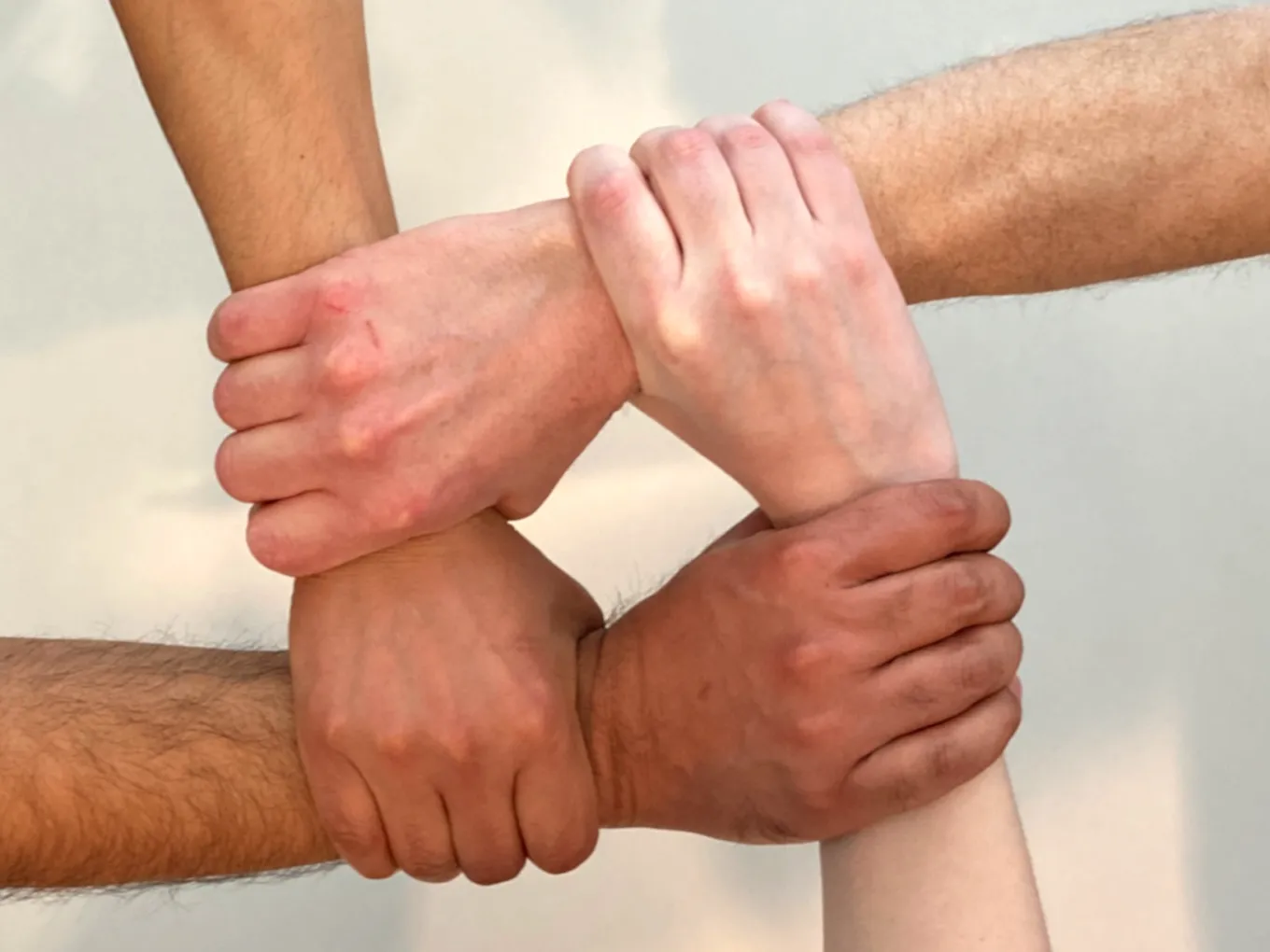Hands connecting in a square