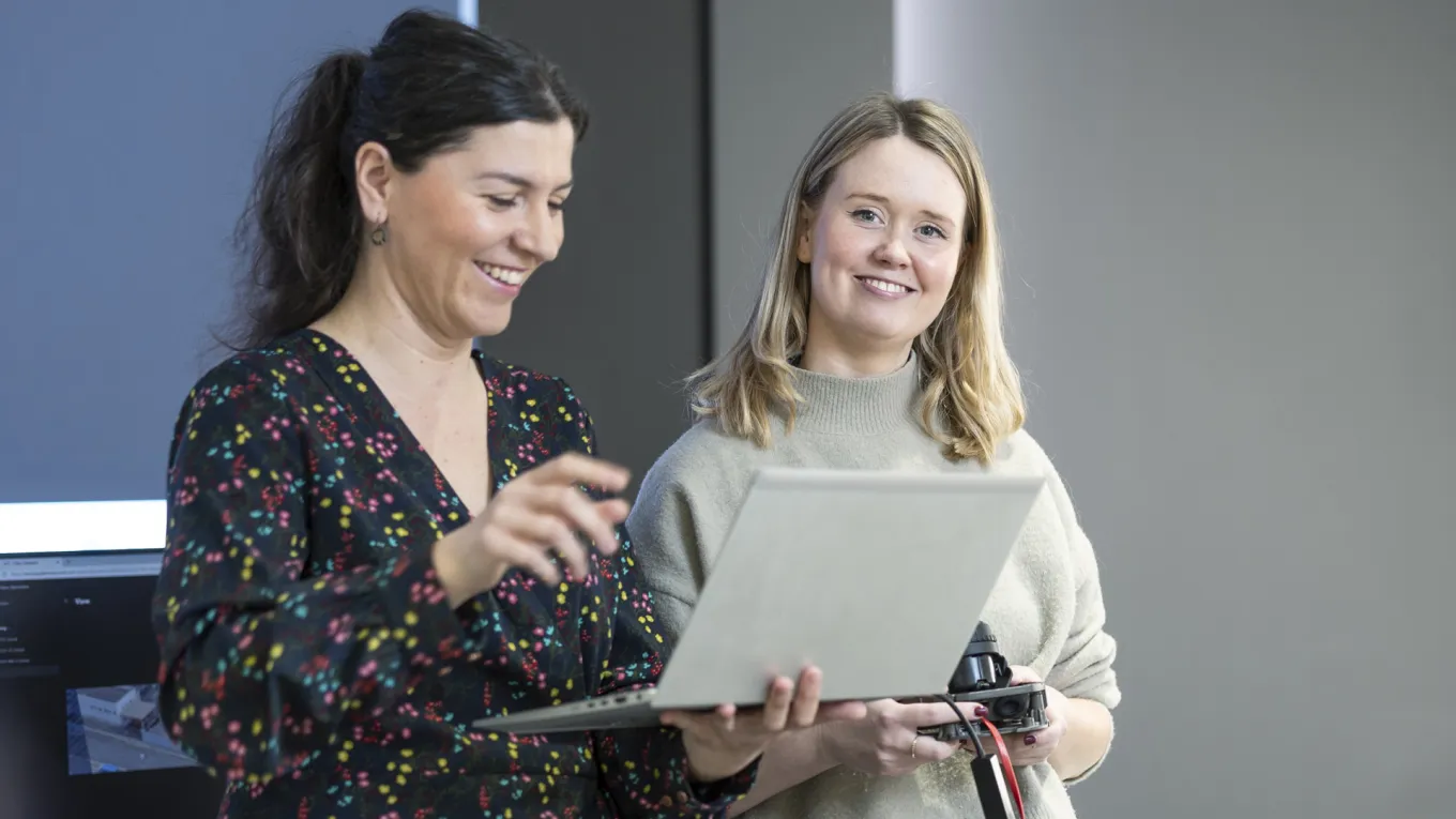 two people in front of laptop