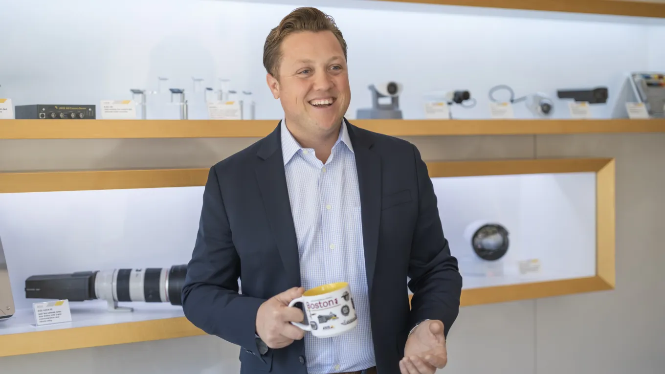 Nick Biagioni holding a cup and smiling 