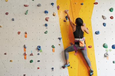 Woman climbing wall