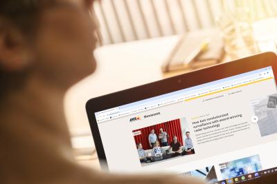 A laptop with Axis Newsroom open on the browser.