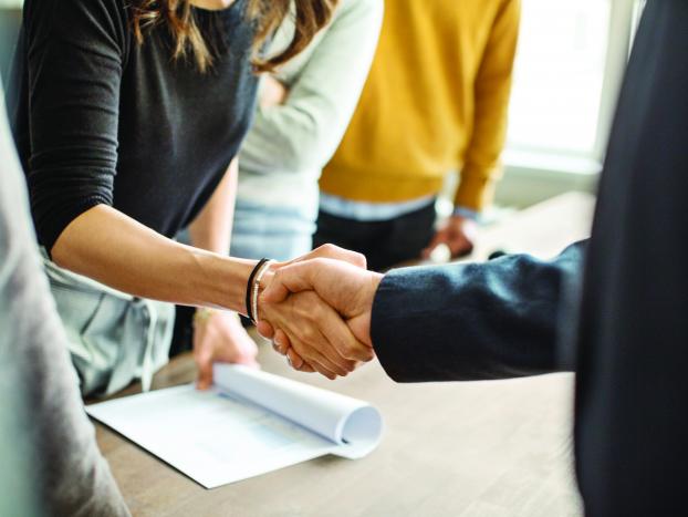 Handshake over a desk