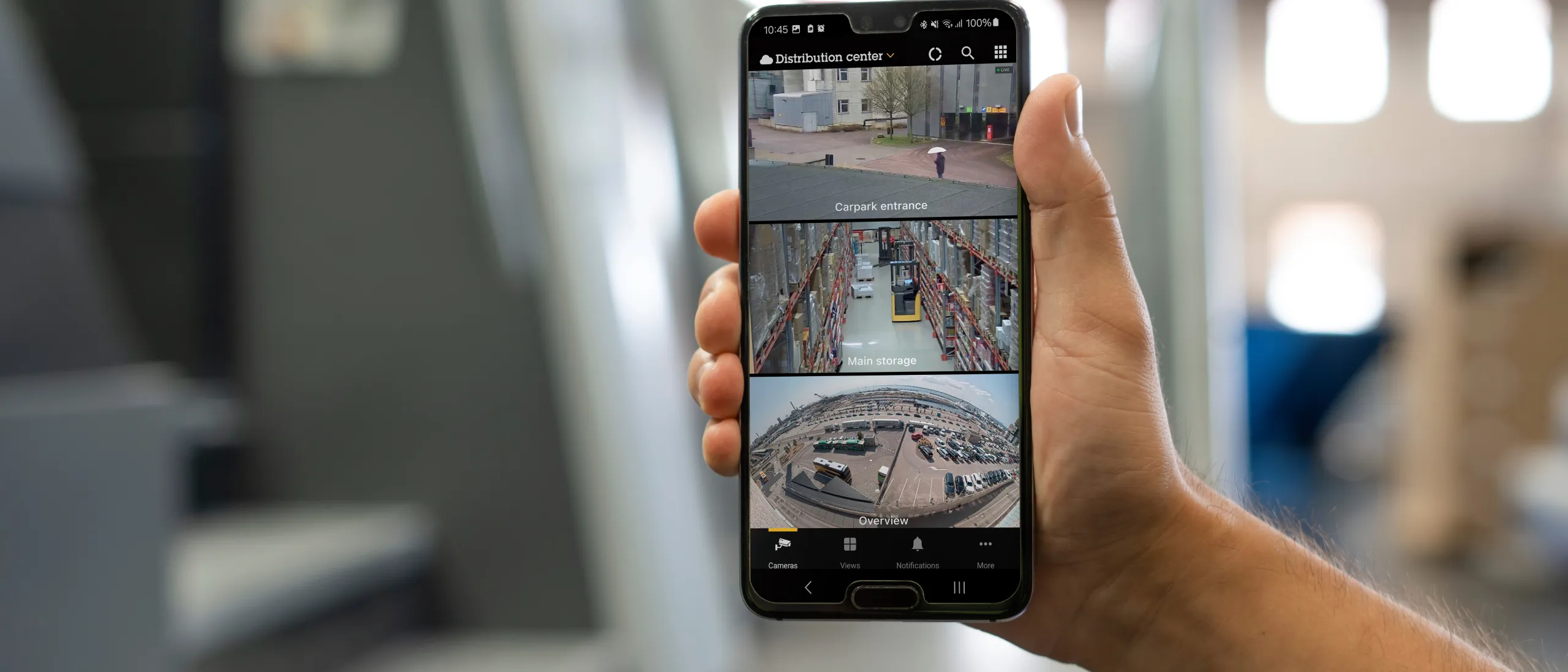 A phone held by a person to show AXIS Camera Station Pro's features all in one place.